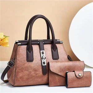 Three-piece vintage brown leather handbag set including shoulder bag and matching wallets