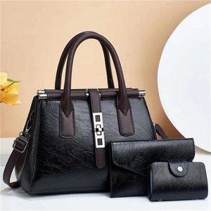 Three-piece set featuring black tote bag, wallet and card holder with brown straps