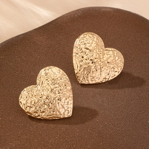 Elegant gold heart stud earrings with a textured hammered finish for a modern summer look