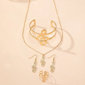 Close-up of golden music note jewelry set featuring necklace, bracelet, and ring