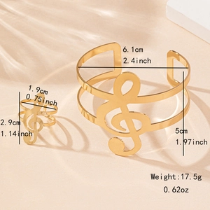 Elegant gold musical note jewelry set featuring an open bangle and matching ring for women