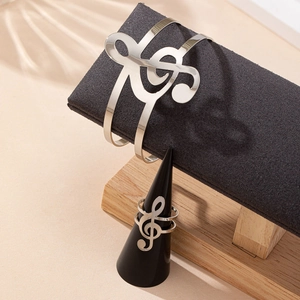 Silver musical note jewelry set with open bangle and ring in a polished minimalist design