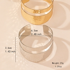 Irregular hammered open cuff bracelet set with hollow double-layer design in gold and silver