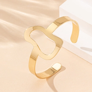 Polished gold irregular hollow open cuff bracelet with a minimalist geometric design