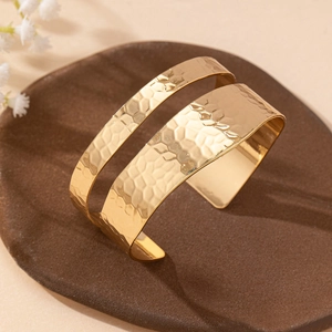 Elegant gold-tone open cuff bracelet with handcrafted hammered texture and dual-bar design