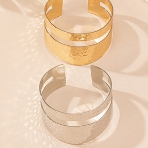 Detailed view of wide hammered texture open cuff bracelet with hollow center design