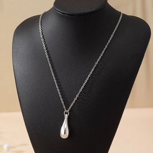 Chic silver water drop pendant necklace on black neck mannequin with minimalist chain