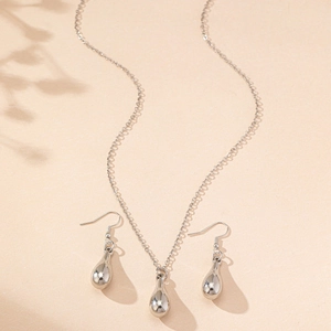 Minimalist silver teardrop jewelry set with polished pendant necklace and matching earrings