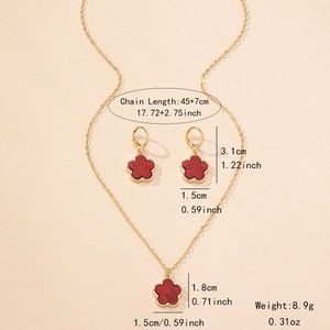 Elegant gold necklace and clover earring set with red petals and product dimensions