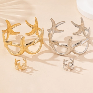 Detailed view of hammered starfish cuff bracelets and matching rings in gold and silver