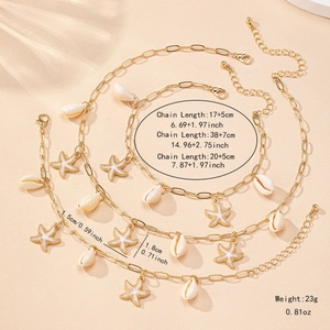 Golden starfish and shell jewelry set with detailed dimensions on sand background