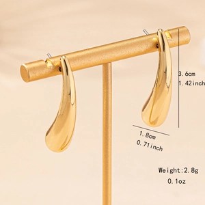 Elegant gold teardrop earrings for women on display stand with size specifications