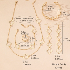 Golden four-leaf clover jewelry set featuring necklace, bracelet, earrings and ring