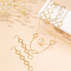 Golden four-leaf clover jewelry set with necklace, bracelet, ring, and earrings