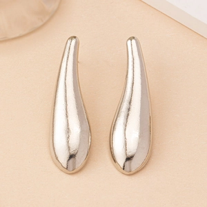 Macro view of silver water drop earrings with unique textured metallic finish and sleek curves
