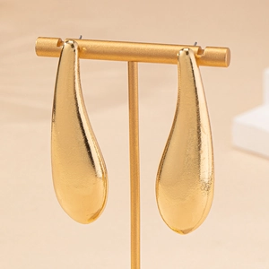Elegant gold teardrop earrings with textured finish and minimalist aesthetic design