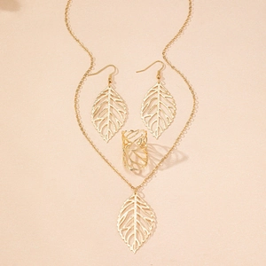 Detailed view of gold hollow leaf necklace, earrings, and ring set with vein texture