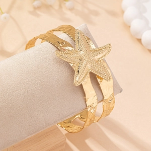 Golden starfish open arm cuff bracelet with hammered texture for summer beach style