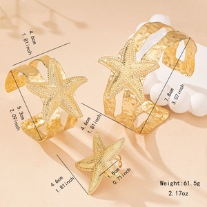 Golden starfish jewelry set including two hammered cuff bracelets and a matching ring