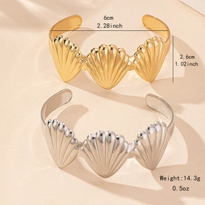 Gothic style gold and silver shell open bangles with detailed triple scallop motif