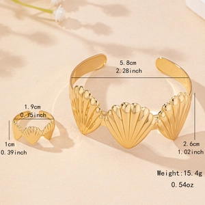 Golden seashell jewelry set featuring an open cuff bracelet and ring for beach vacation