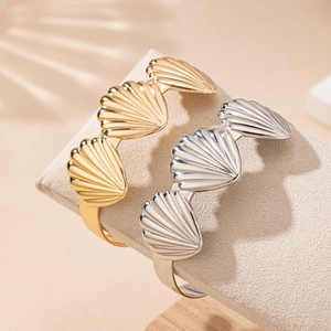 Polished shell-shaped open cuff bracelet set in gold and silver finish for women