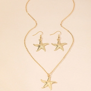 Close-up of golden starfish necklace and earrings set with detailed ocean texture