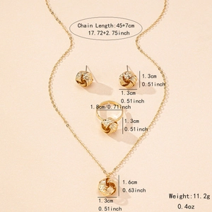 Golden knot jewelry set with necklace, earrings and ring on a soft pink background