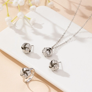 Elegant silver-tone jewelry set with textured knot necklace, stud earrings, and ring