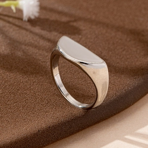 Minimalist silver geometric half-moon ring set with smooth polished finish on dark background