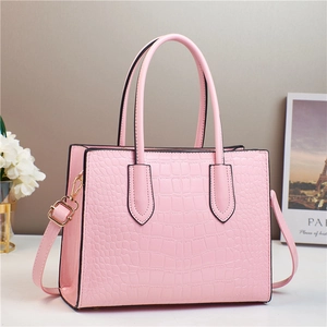 Sac à main rose à motif lézard avec détails dorés et bandoulière amovible