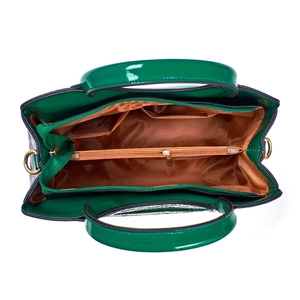 Interior view of green patent leather handbag showing multiple compartments and zip pocket