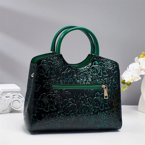 Dark green patent leather handbag with 3D floral embossing and round handles