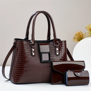 Detailed close-up of dark brown faux crocodile patent leather handbag set in 3 pieces