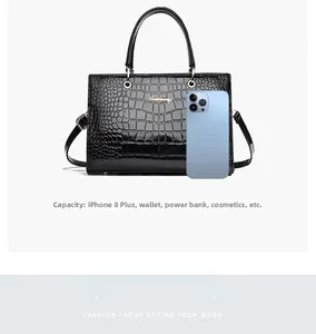 Detail view of large stone pattern handbag capacity showing it fits a large smartphone