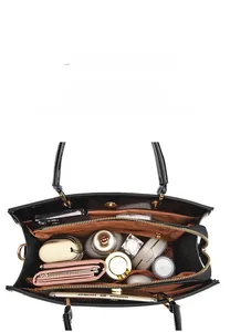 Macro view of large capacity black tote bag interior with iPad and accessories