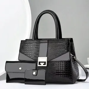 Close-up of three-piece black patent leather handbag set with luxury crocodile texture