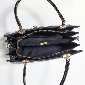 Top view of large capacity glossy tote bag showing multi-compartment interior and gold hardware