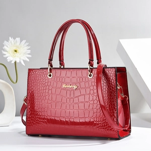Elegant red crocodile texture handbag with polished gold logo and detachable shoulder strap