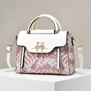 Elegant white crossbody bag with pink cloud patterns and gold swan pearl tassels
