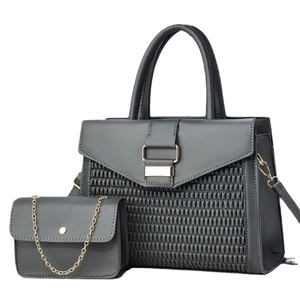 Detail view of dark grey 2-piece handbag set featuring textured weave and gold hardware