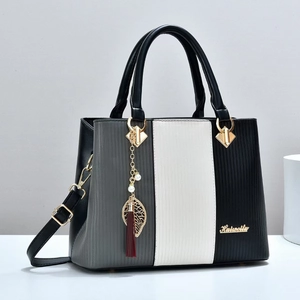 Three-color striped leather handbag with elegant leaf tassel charm and long shoulder strap