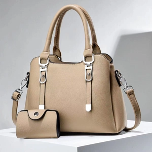 Large khaki tote bag with matching wallet on a geometric stand, grainy leather texture