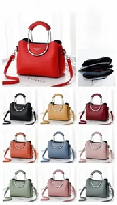 Detailed display of ten color options for this PU leather crossbody bag with metal handles