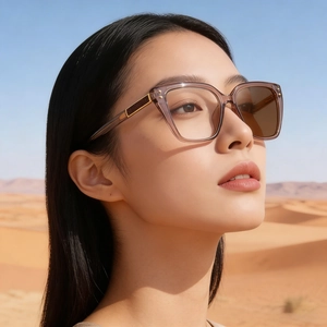 Fashionable oversized cat-eye sunglasses with gradient brown frames and metal-trimmed temples