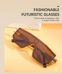 Detail of oversized futuristic sunglasses with tea brown lenses and gold rivets
