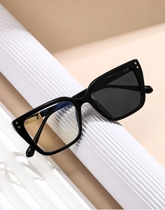 Detailed view of cat-eye sunglasses featuring light-sensitive photochromic lenses in black frame