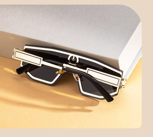 Detail of premium oversized flat top sunglasses with luxury gold accents on black temples