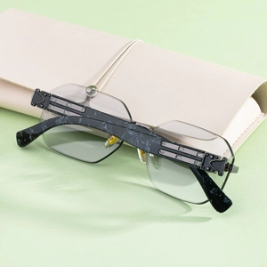 Detail of marble pattern temples and silver metal hardware on square rimless sunglasses