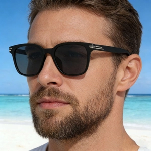 Men's square polarized sunglasses with black frames and silver metal details by the beach